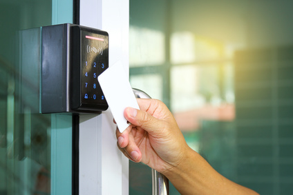 Close-up hand inserting keycard to lock and unlock door